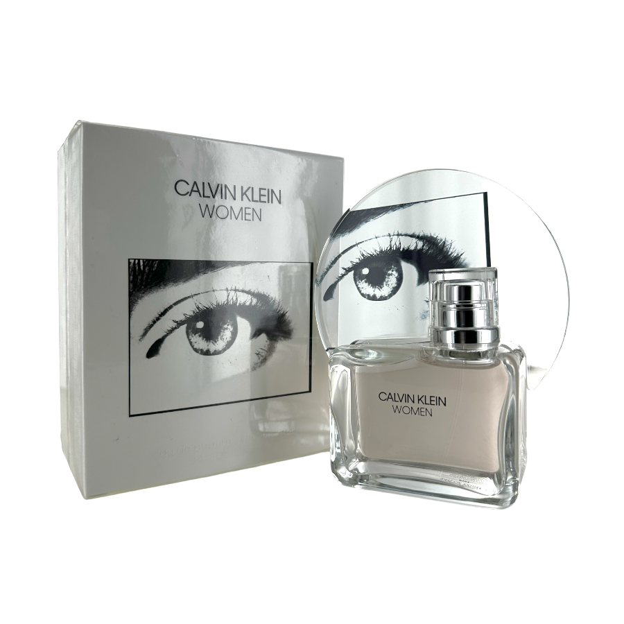 A Calvin Klein Women's Eau de Parfum spray bottle with a reflective cap, alongside its packaging box which has a picture of an eye on the front. Both items are displayed against a white background.