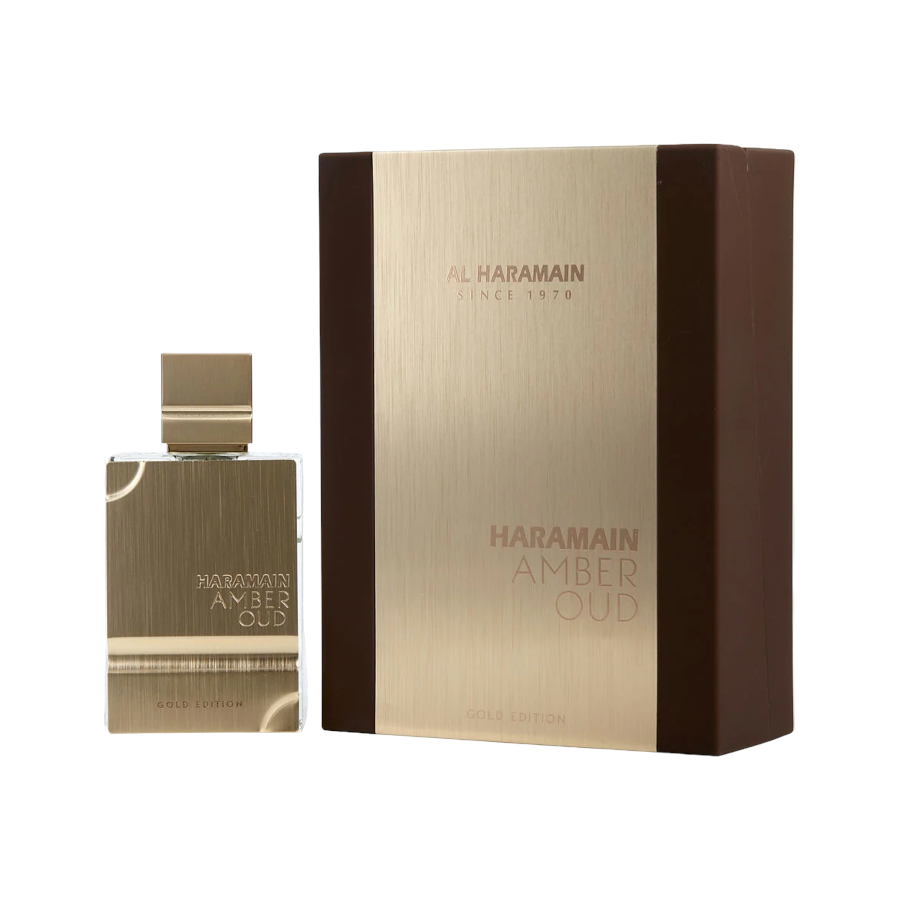 Al Haramain Amber Oud Gold Edition EDP in a glass bottle with gold label, alongside its brown packaging box with gold text.