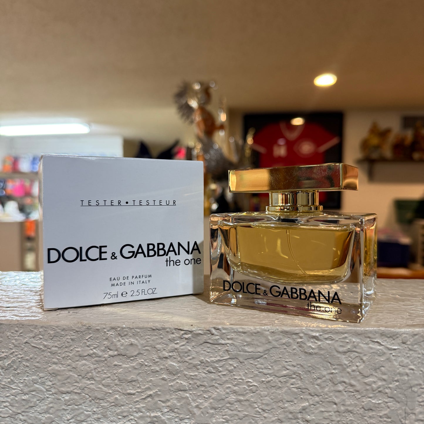 Dolce & Gabbana perfume bottle and packaging on a surface with a blurred background