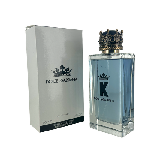Dolce and Gabbana 'K' EDT perfume bottle and packaging, featuring a clear glass bottle with a blue label, a white box with a crown design, and the Dolce and Gabbana logo.
