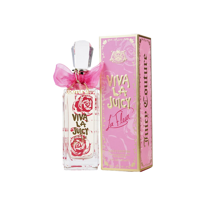 A bottle of Juicy Couture Viva La Juicy La Fleur eau de toilette with a pink bow on top, alongside its pink packaging box.