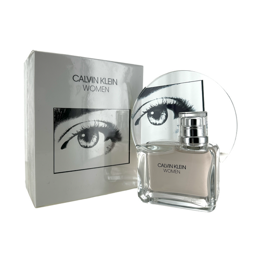 A Calvin Klein Women's Eau de Parfum spray bottle with a reflective cap, alongside its packaging box which has a picture of an eye on the front. Both items are displayed against a white background.