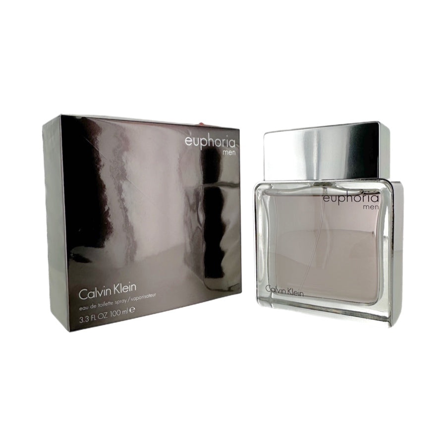 A bottle of Euphoria Men's Eau De Toilette Spray by Calvin Klein, with its packaging box. The bottle is silver-colored, and the box is black and silver with 'Euphoria' and 'Calvin Klein' branding.