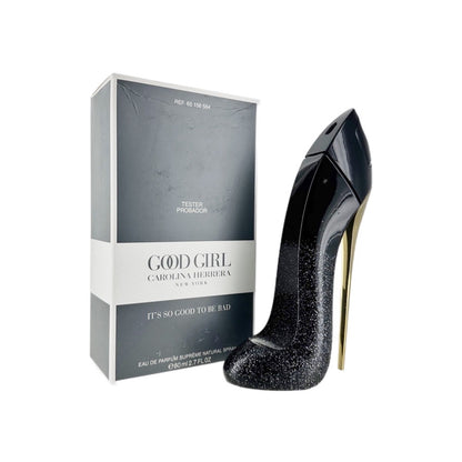 A tester package and a bottle of 'Good Girl Supreme' eau de parfum spray for women by Carolina Herrera, showing the product's packaging and the high heel shoe that is part of the product's imagery.