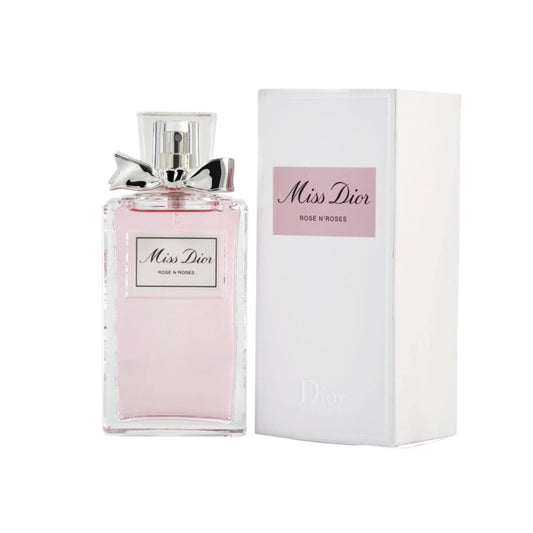 A bottle of Miss Dior Roses N' Roses Eau de Toilette Spray with a pink label, next to its white packaging box with the Christian Dior logo.