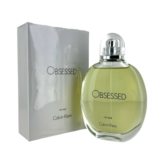 A bottle of Calvin Klein Obsessed EDT for men with its packaging box. The bottle is clear and showcases the light yellow to orange hued liquid inside.