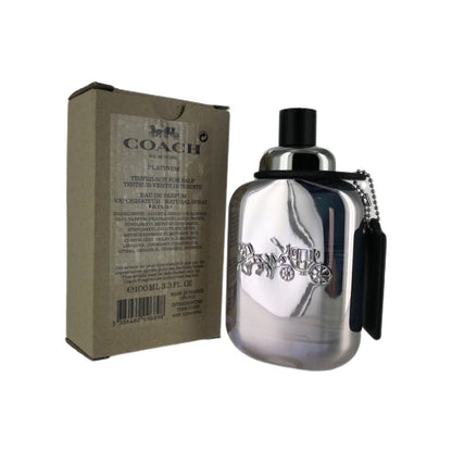 A silver spray bottle of Coach Platinum EDP for men with a black cap and a label that includes the brand name and fragrance details, alongside its cardboard packaging.