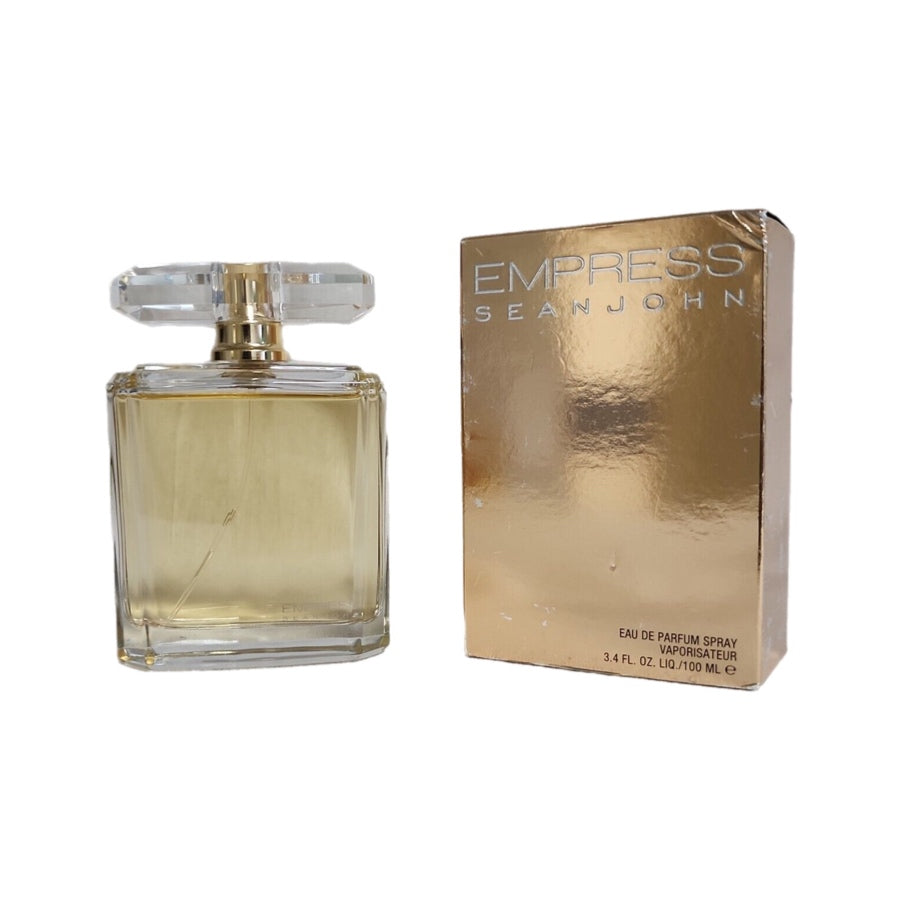 A bottle of Sean John Empress EDP with a gold-tone cap and a box with the fragrance's name and brand displayed prominently.