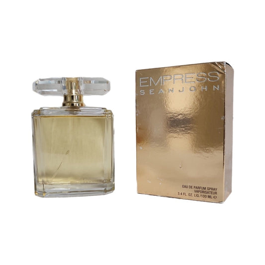 A bottle of Sean John Empress EDP with a gold-tone cap and a box with the fragrance's name and brand displayed prominently.
